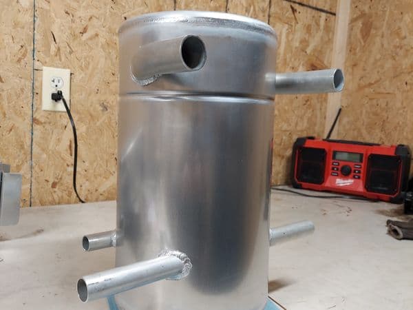 Aluminum surge tank with multiple inlet and outlet ports