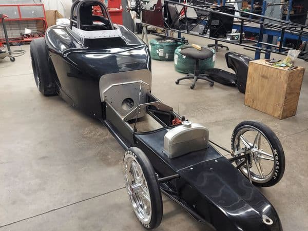 Black drag racing chassis in workshop