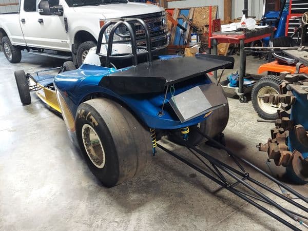 Blue and yellow dragster in workshop